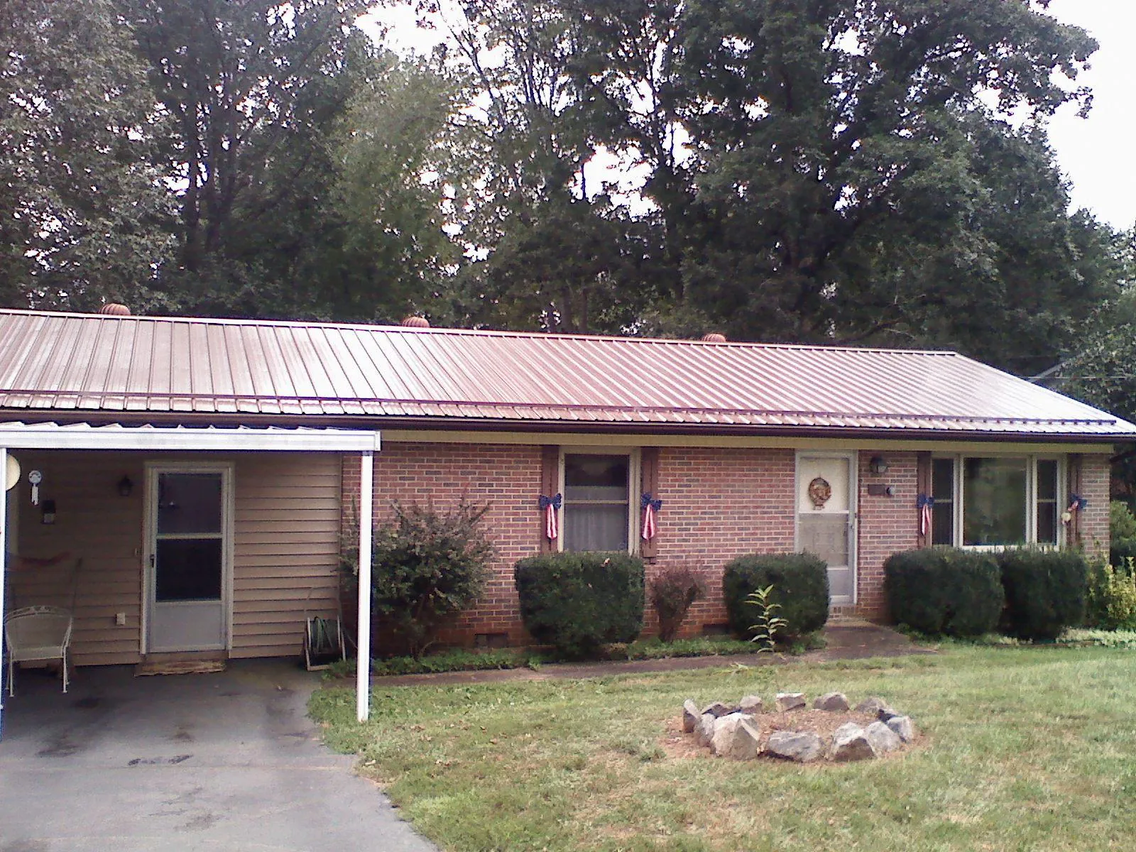 Bronze metal roof and carport on a brick ranch home — Roof Repair work by our crew in Shasta
